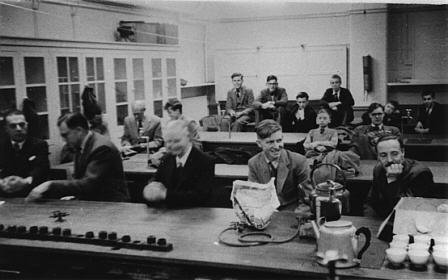 The picture shows members in the very early days of the Club, we are not certain but we believe this was taken at the Roxeth Manor School in the Science Laboratory.